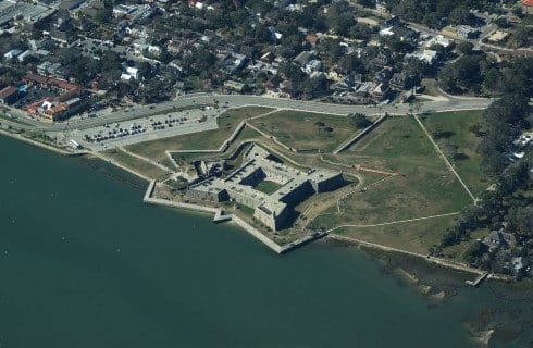 Overhead view of an old star shaped fort next to the ocean